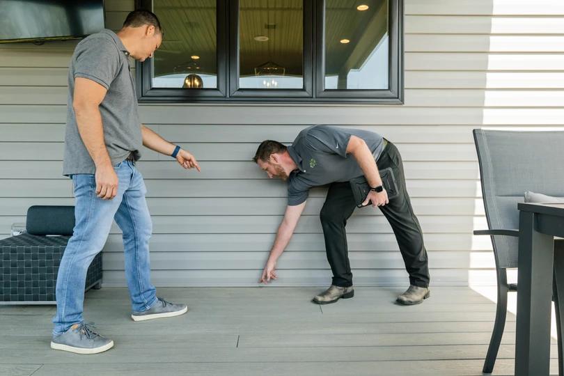 Amco Ranger employee talking with customer about possible termite nest