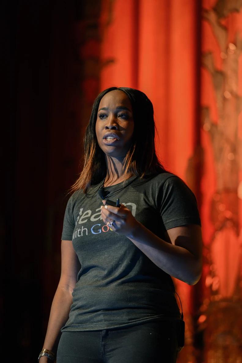 a woman on stage at the Google Soulfest