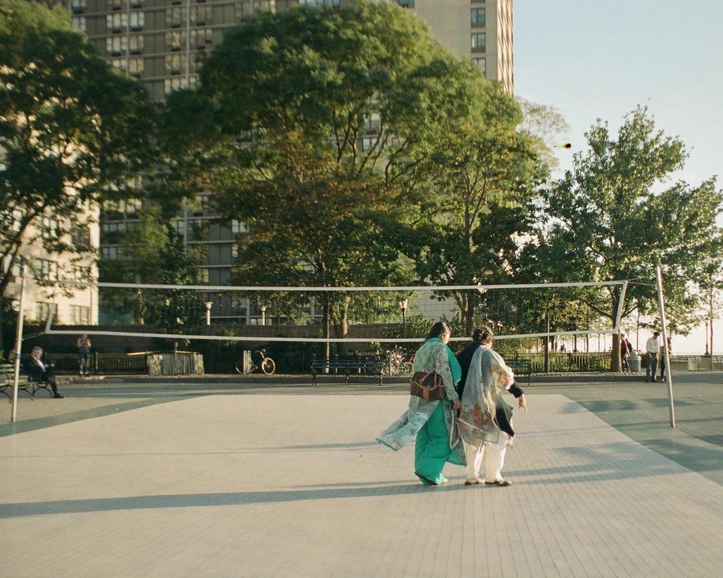Ladies walking by a volleyball net