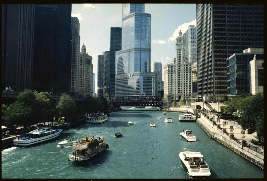 a river that goes through a city, with boats sailing on it