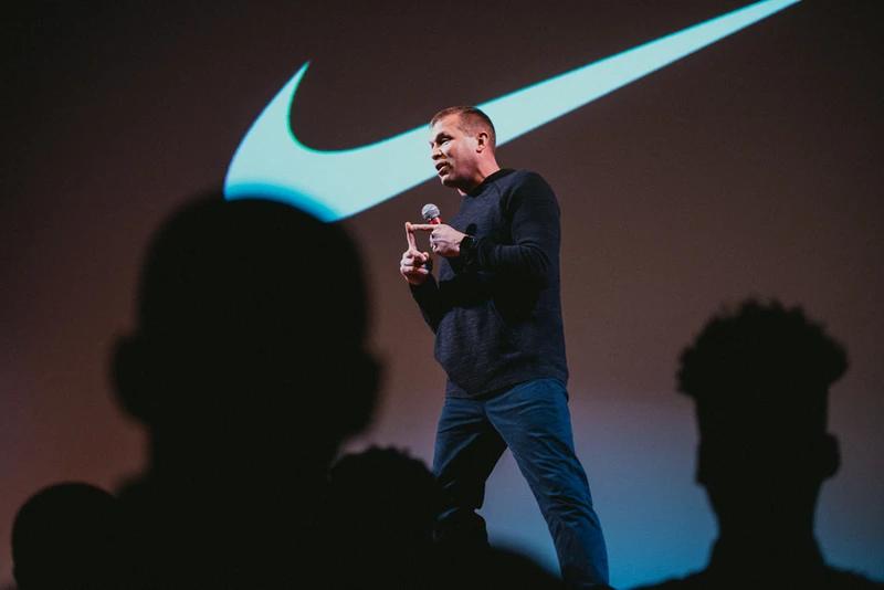 a coach on stage talking to the players at the niké sb 51 event