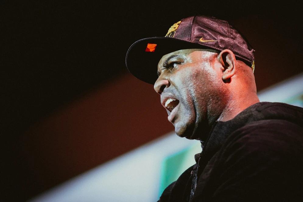 the coach on a stage talking to the players at the niké sb 51 event