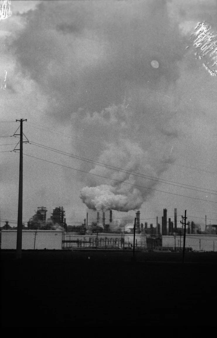 Smoke from a industrial area across a body of water, seen from the harbour
