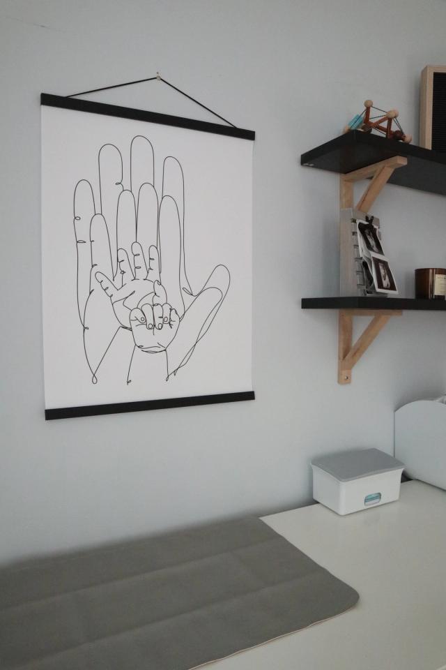 shelves and art pieces above crib