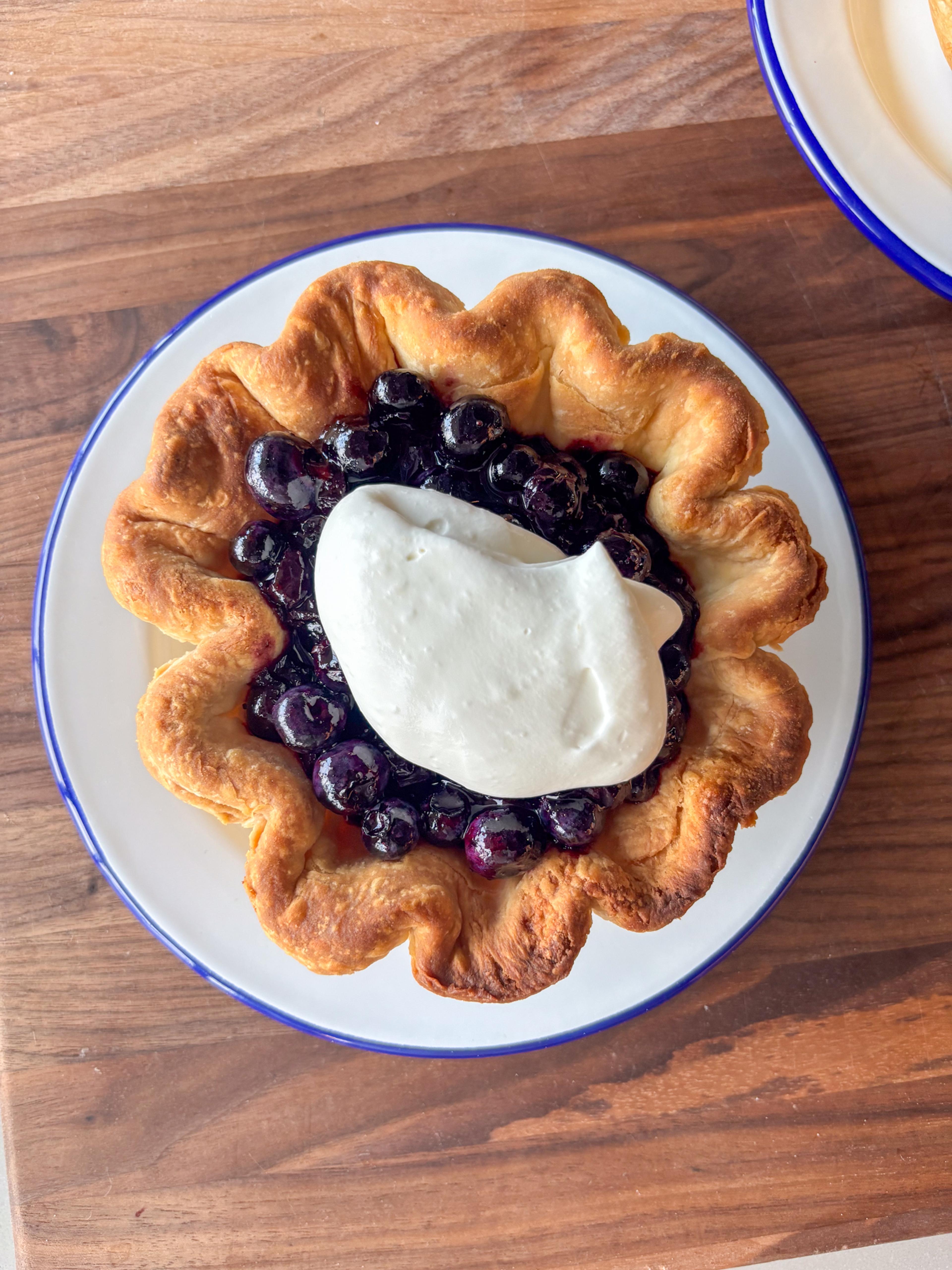 Blueberry pie with a dollop of whipped cream