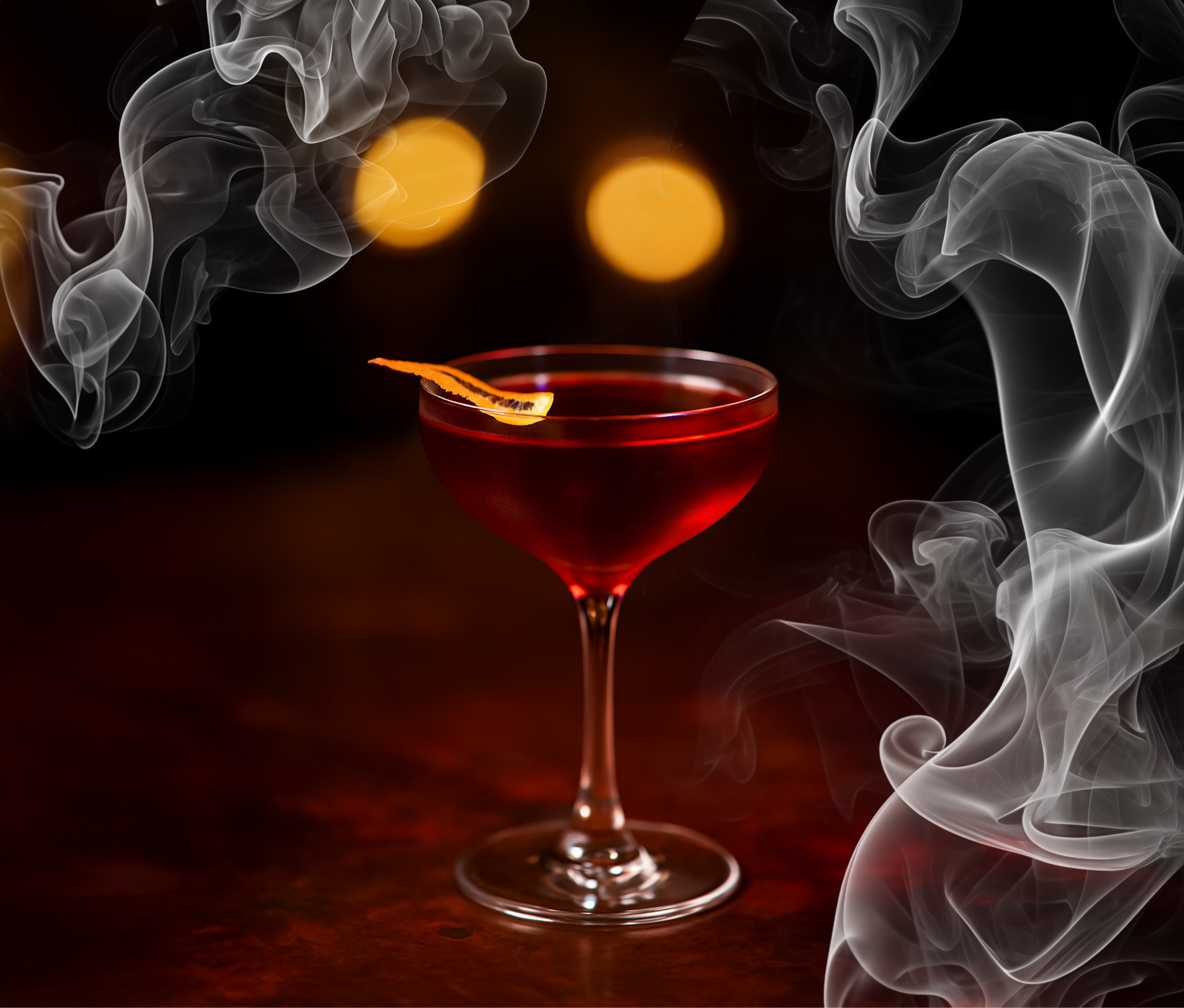 red cocktail in coupe glass with lemon peel garnish