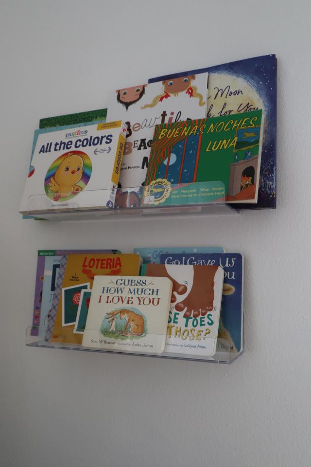 books on shelves above nursery area