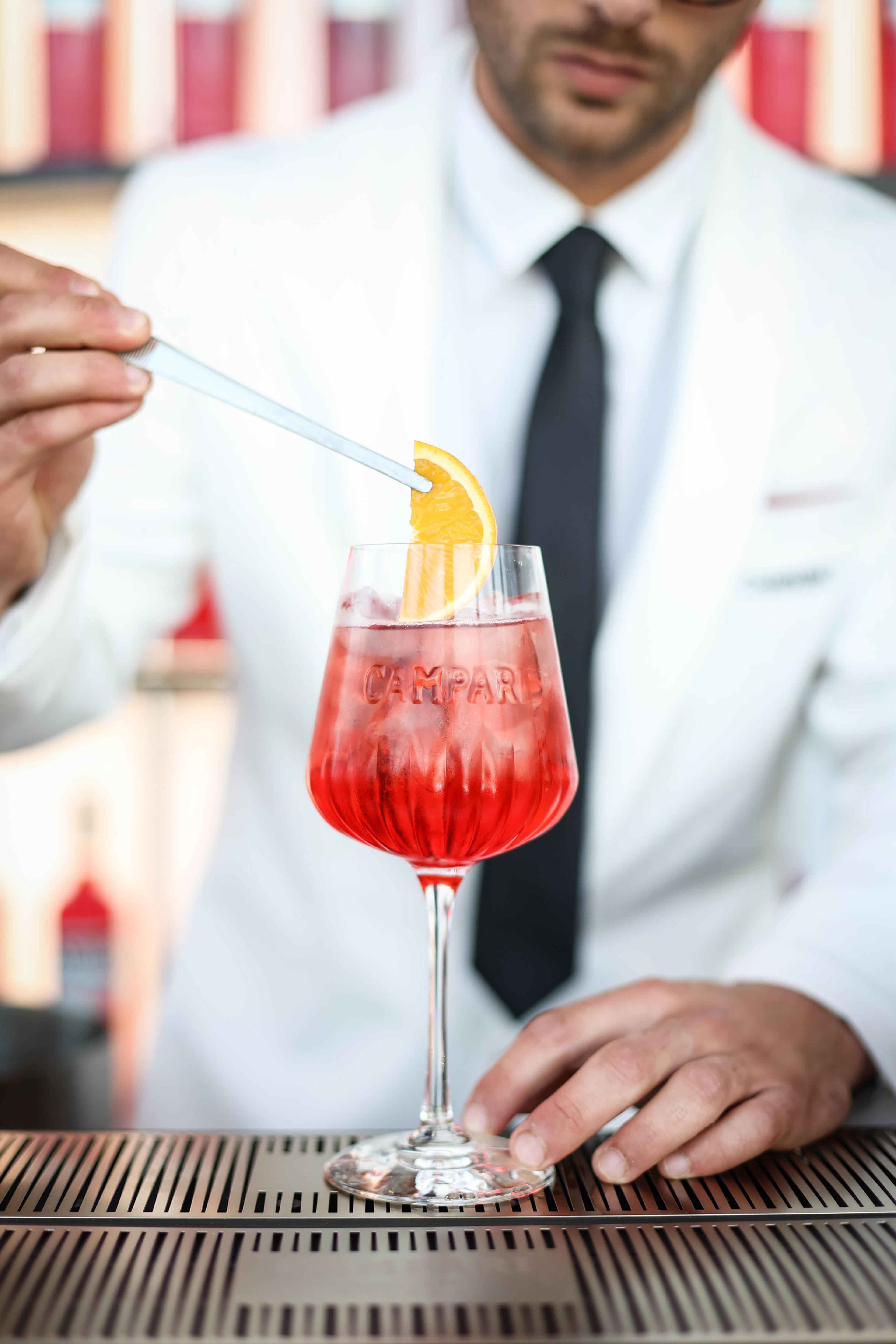 bartender mixing up a Campari spritz