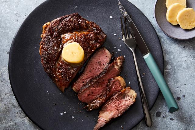 perfectly cooked sliced steak with pat of butter on top