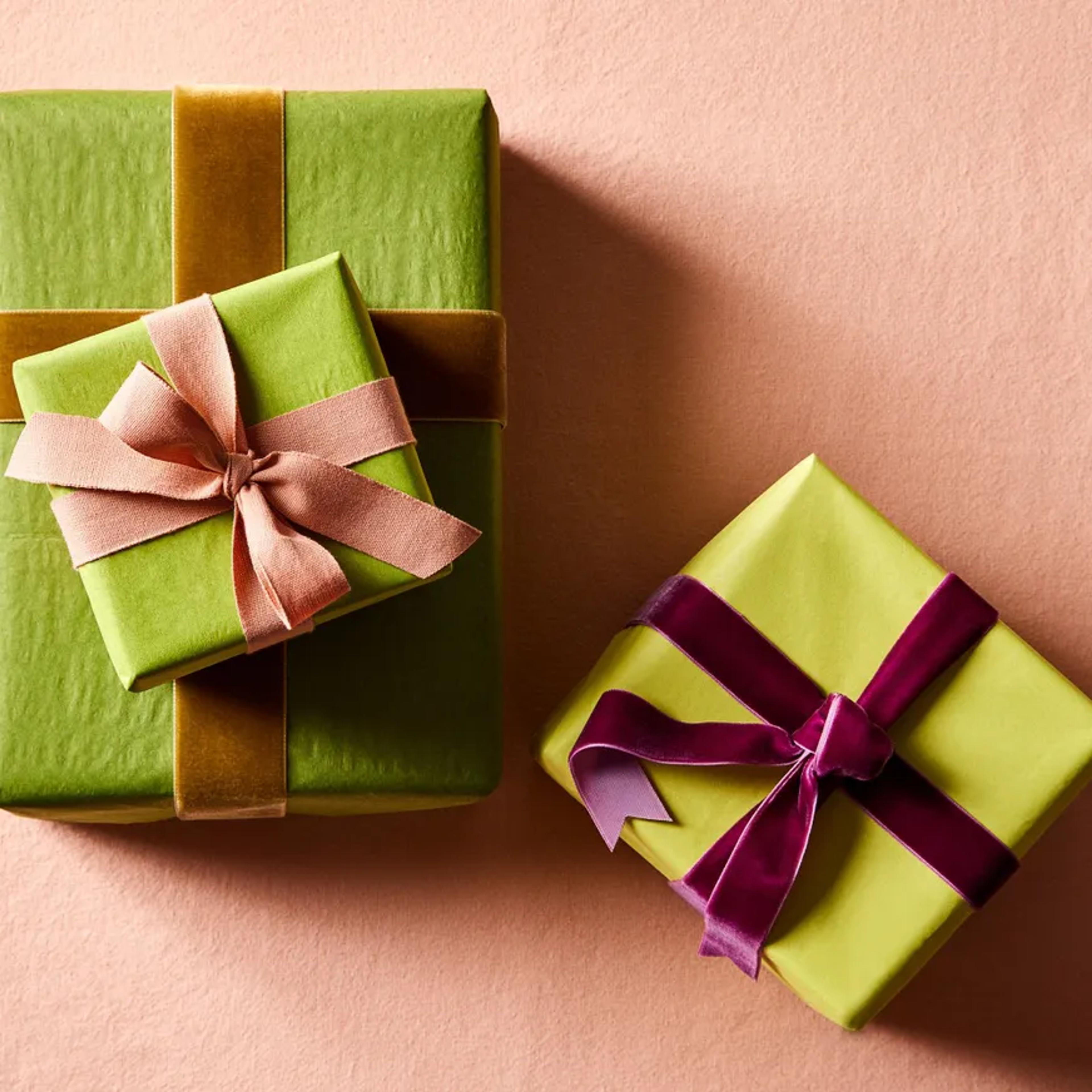 boxed gifts in green with pink, purple and bronze ribbon