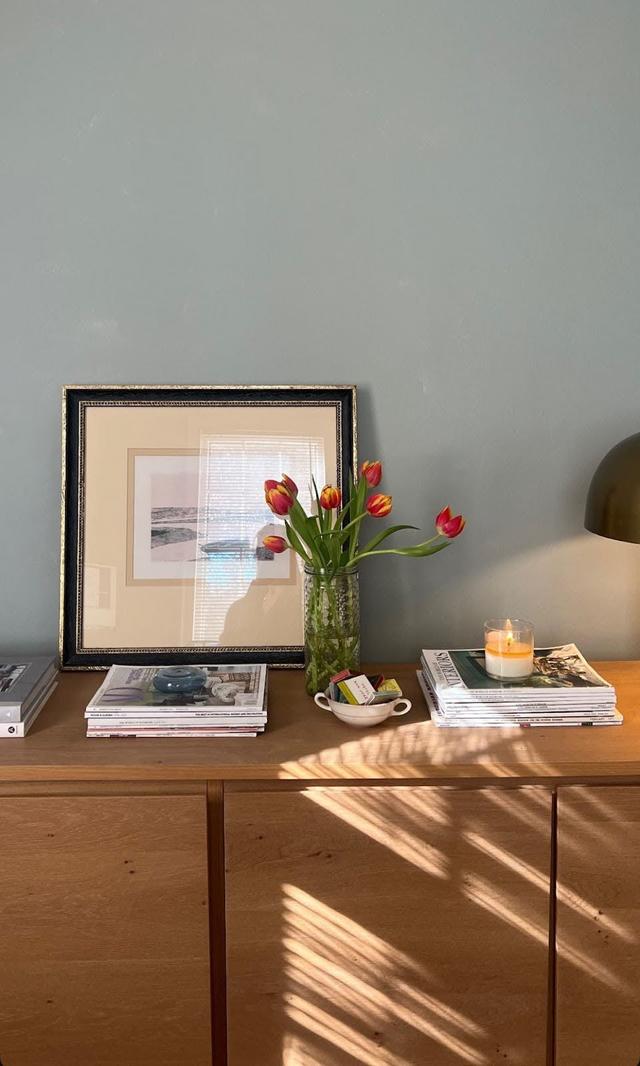 flower vase full of tulips on table