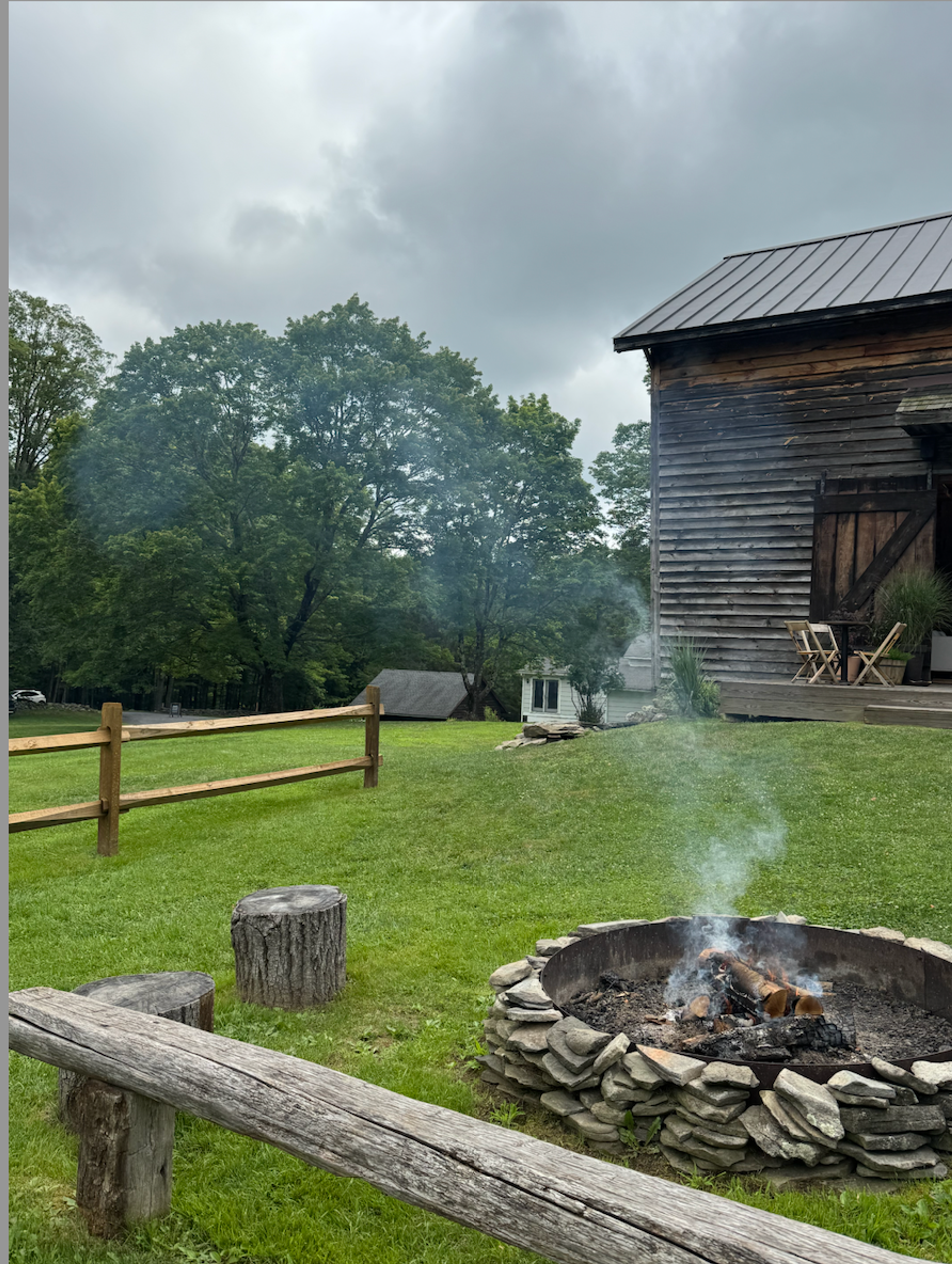 barn in field with campfire lit