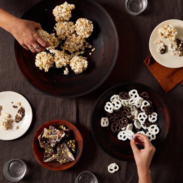 halloween candy, popcorn balls, and chocolate covered pretzels on table