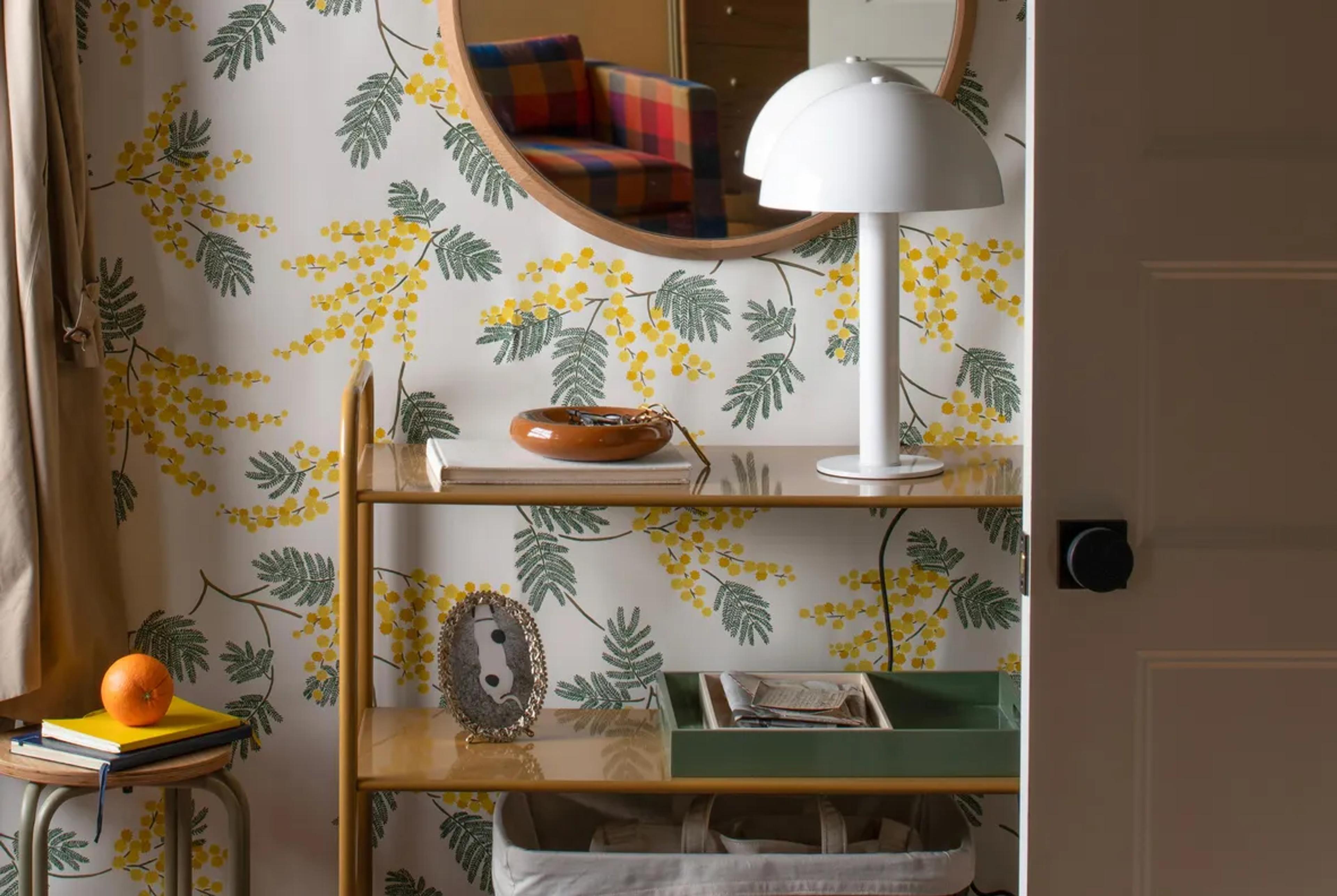 Shelf against floral wallpaper