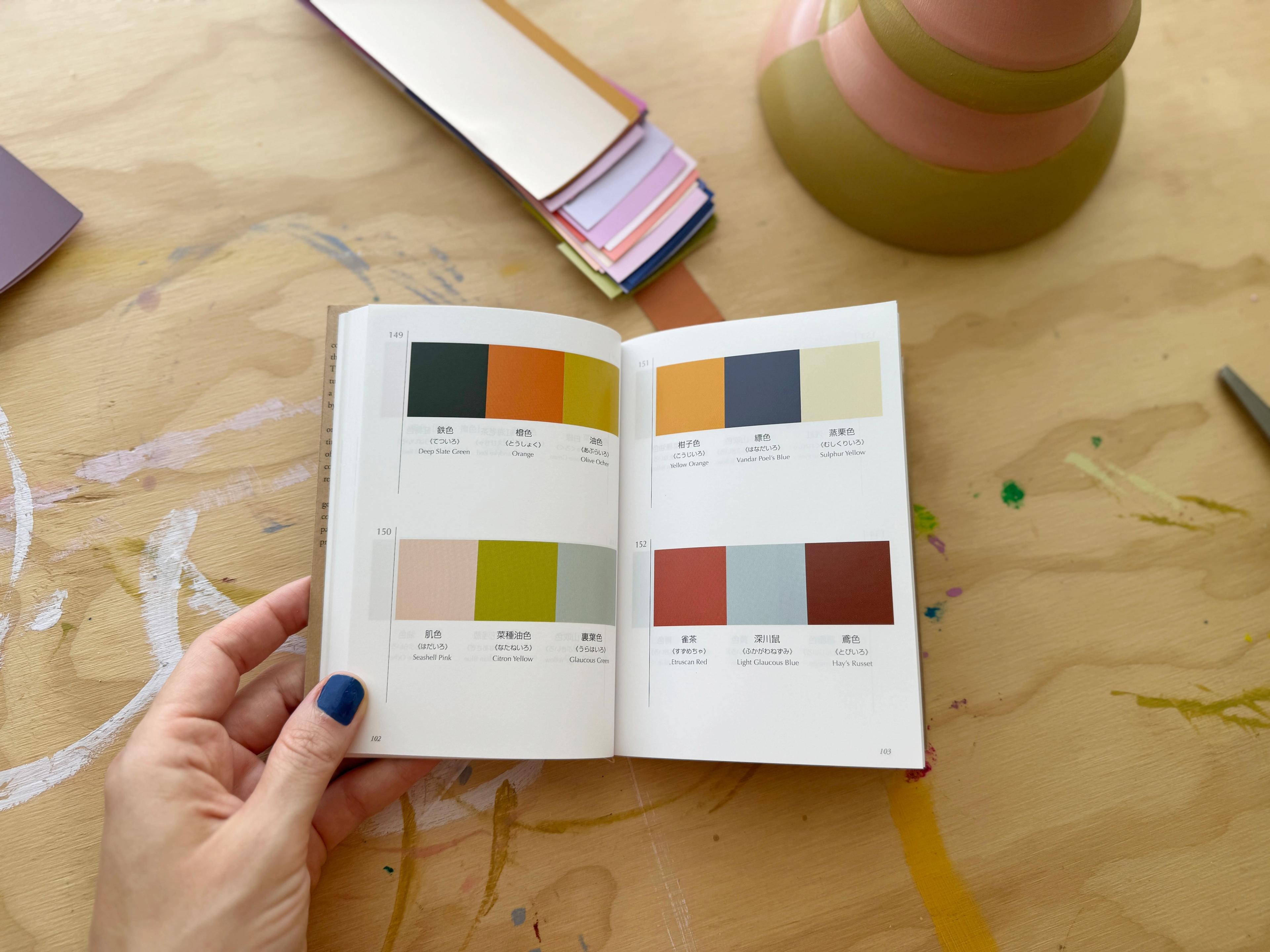 designer Lu Loveless holding open color book