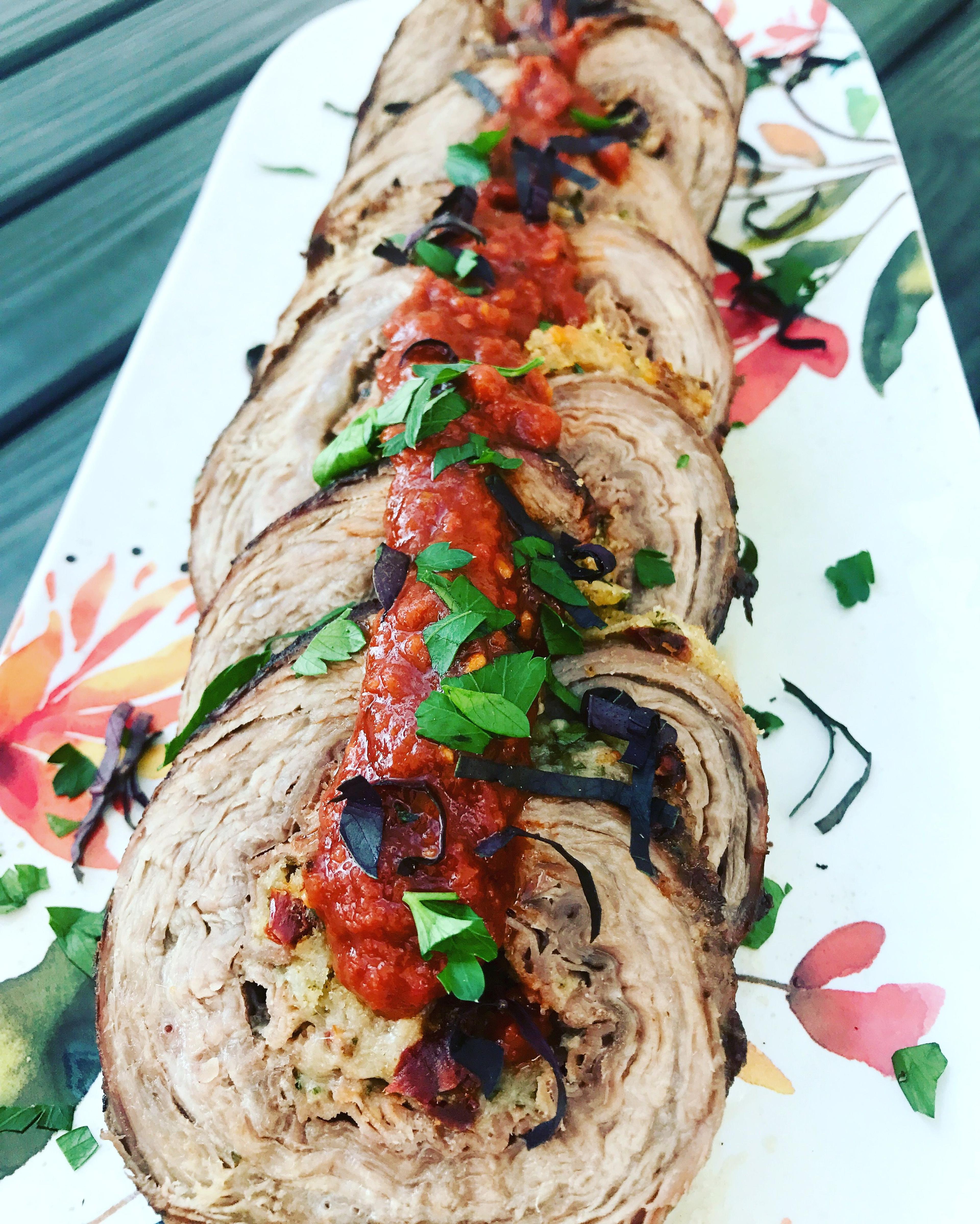 Braciole with sundried tomato port wine reduction sauce beauty shot. 