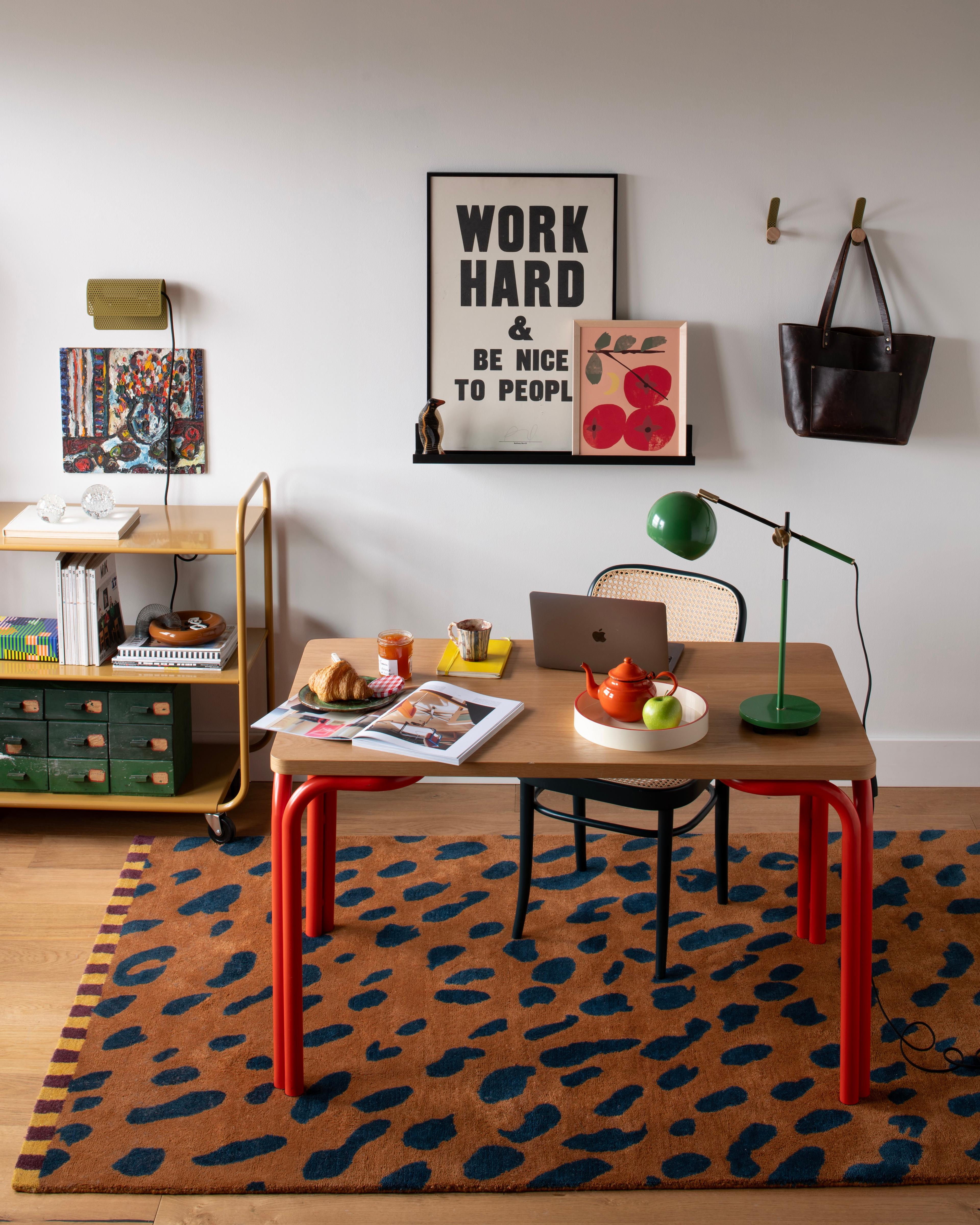 inside home office with desk, computer, chairs, and posters