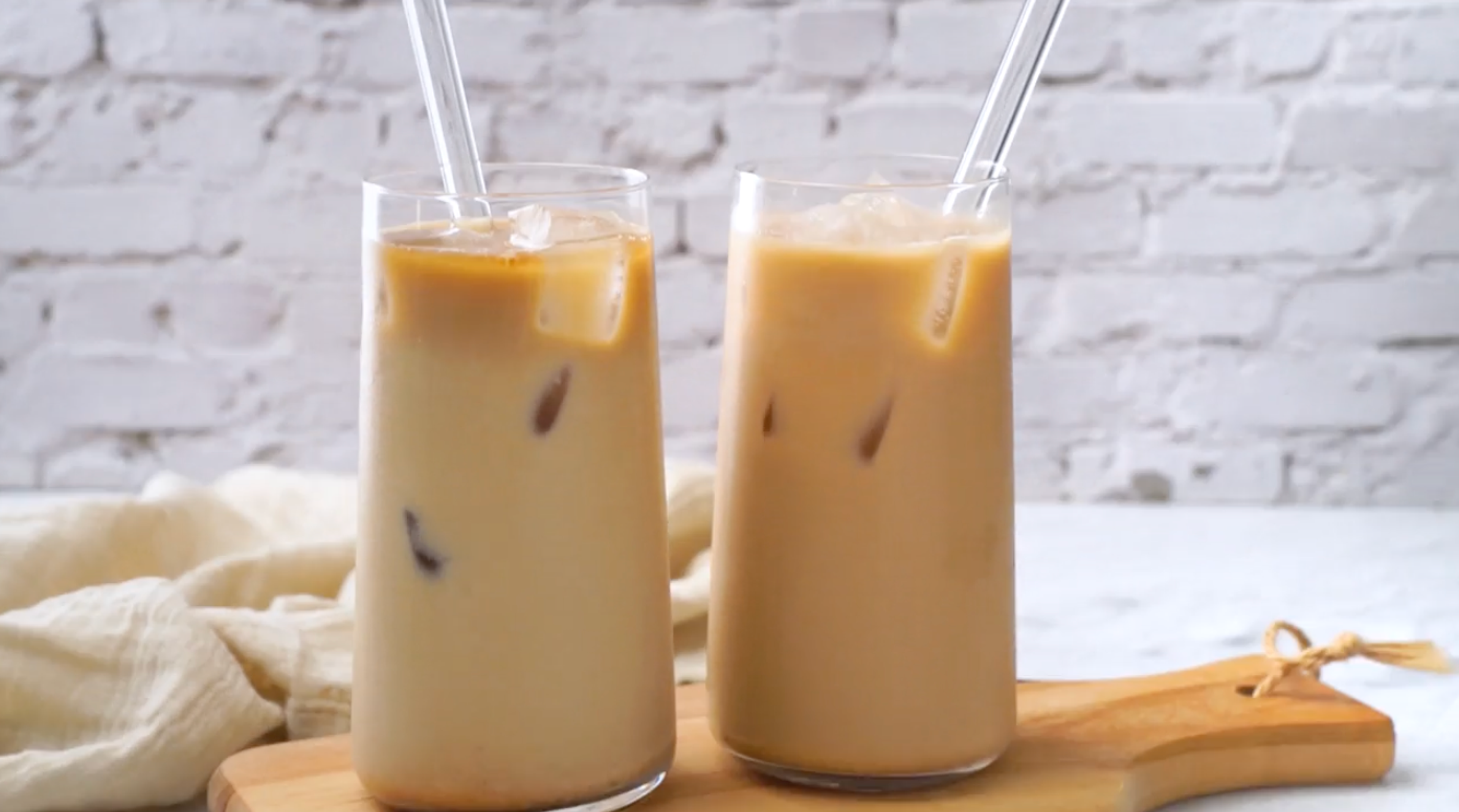 two glasses of iced pumpkin cream cold brew on counter