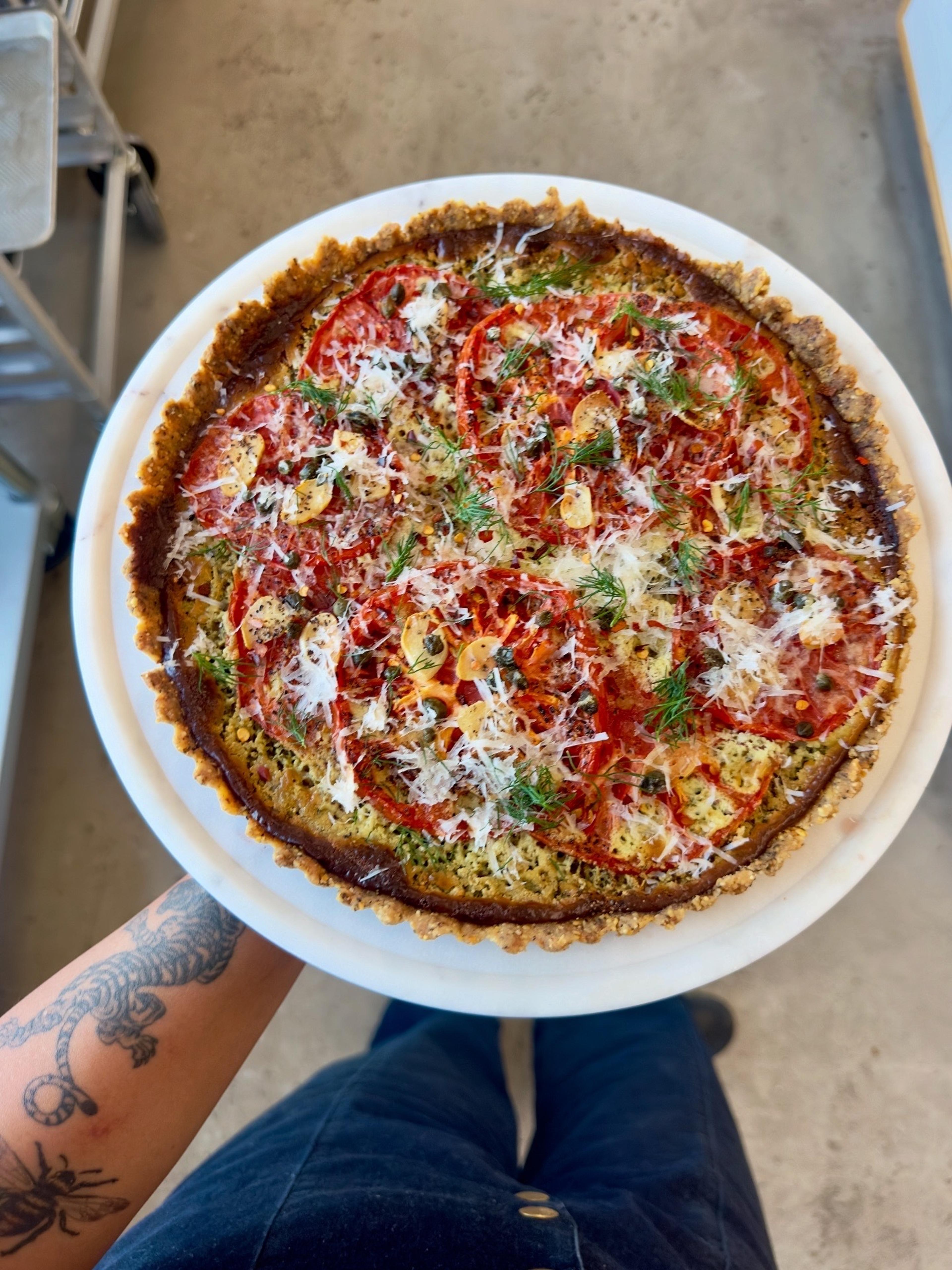 homemade heirloom tomato tart with basil cream and fresh parmesan