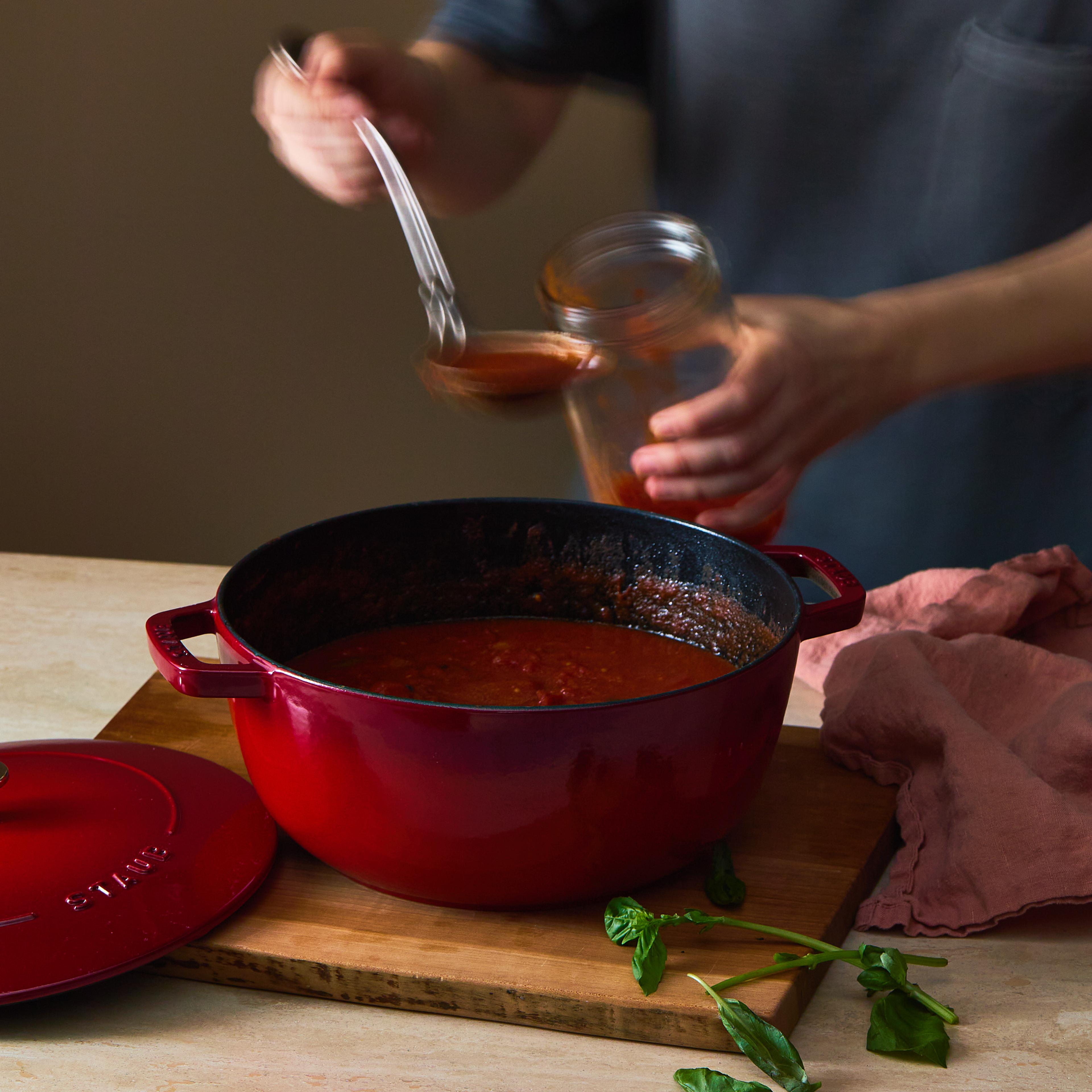staub dutch oven with tomato soup and ladle
