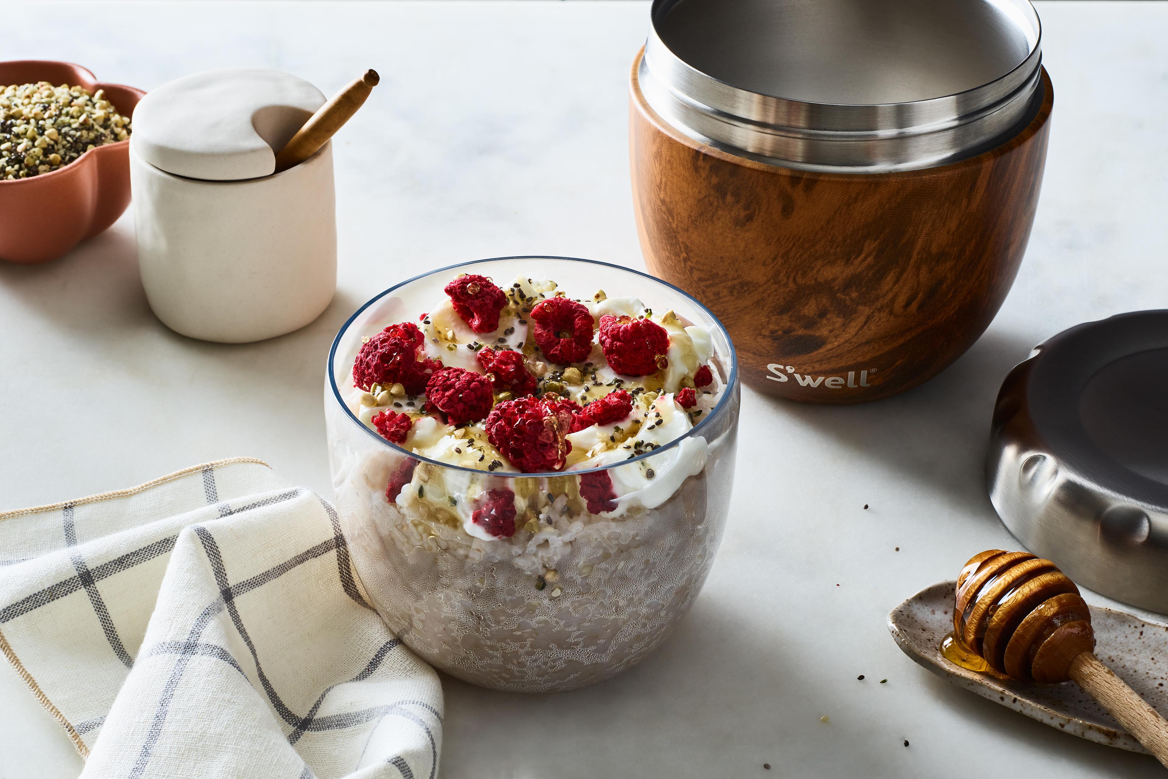Yoghurt and granola on a breakfast table.