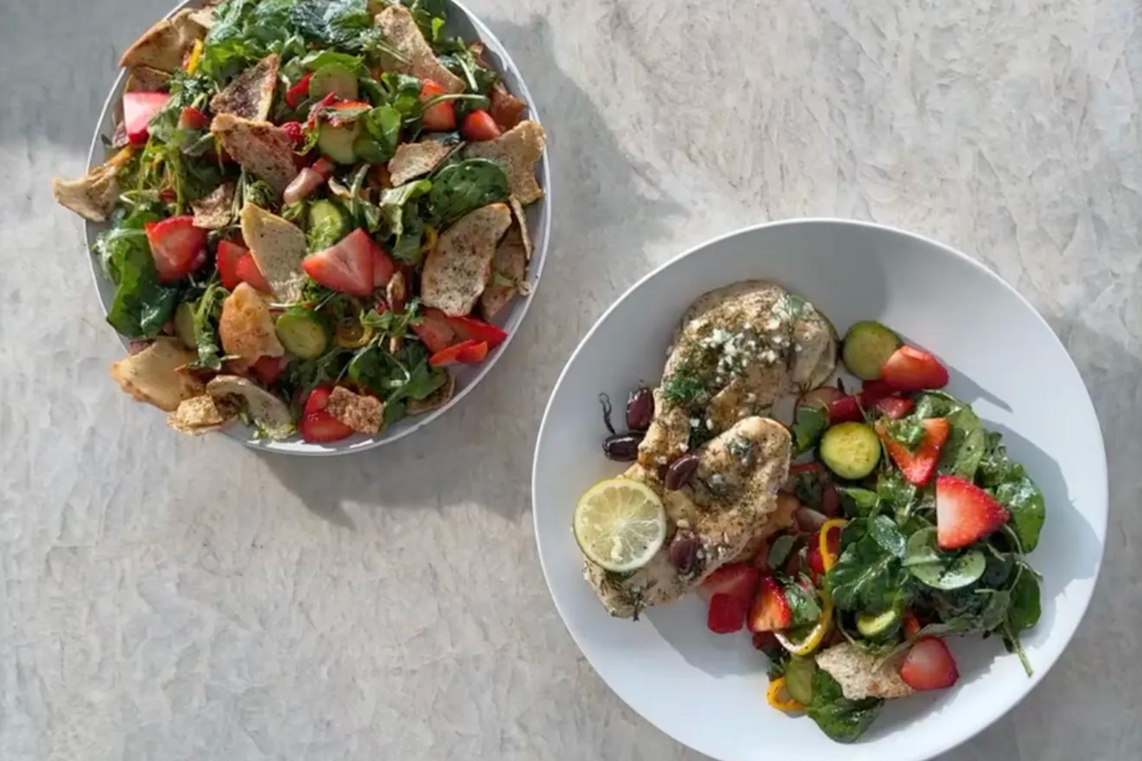 two bowls of Strawberry, Arugula & Spinach Fattoush With Lime Chicken