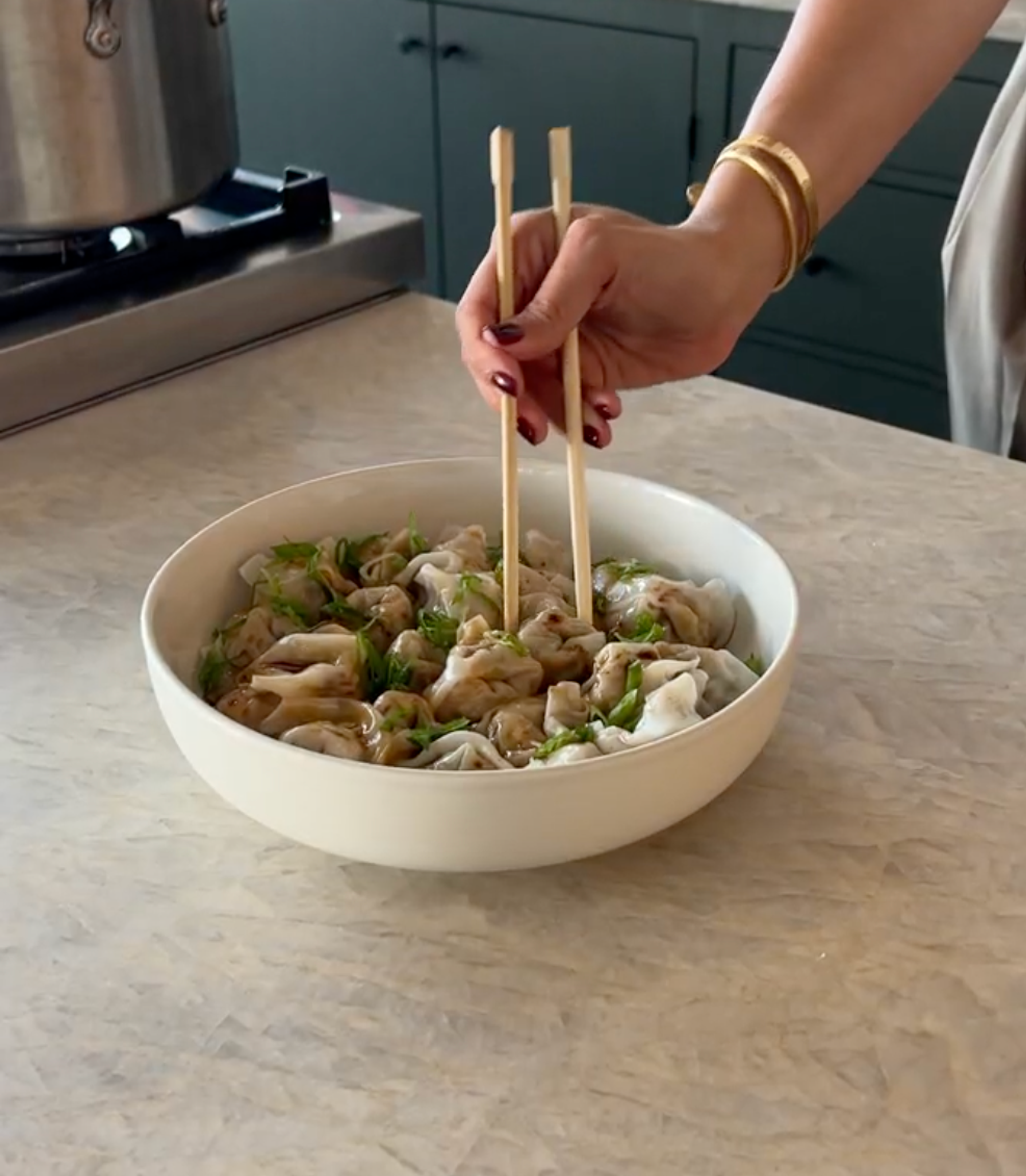 bowl of wontons with chopsticks