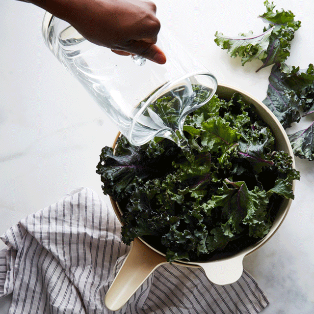 washing salad greens in bowl