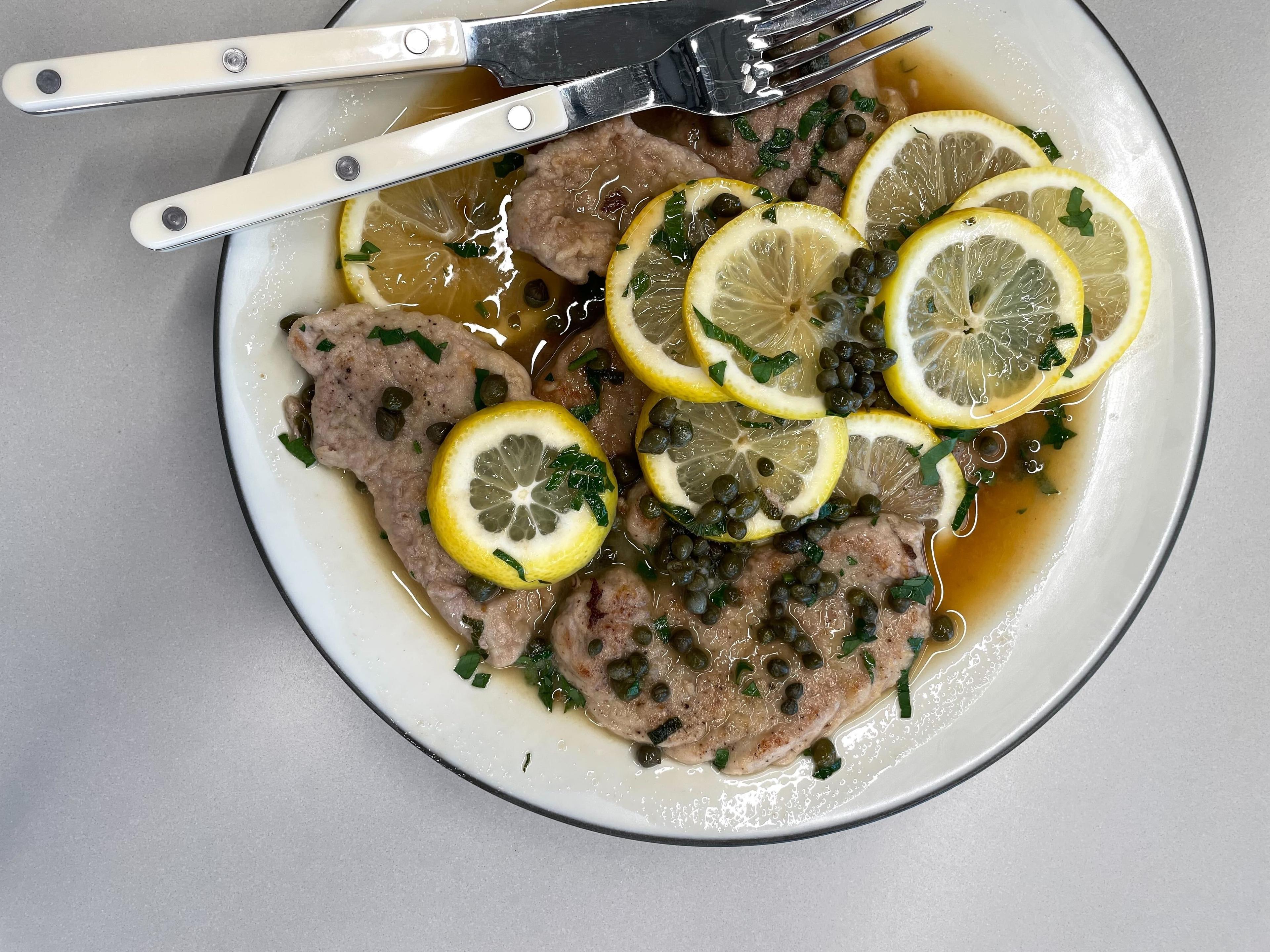 plate of high-protein pork picatta with caper garnish on plate in Food52 test kitchen