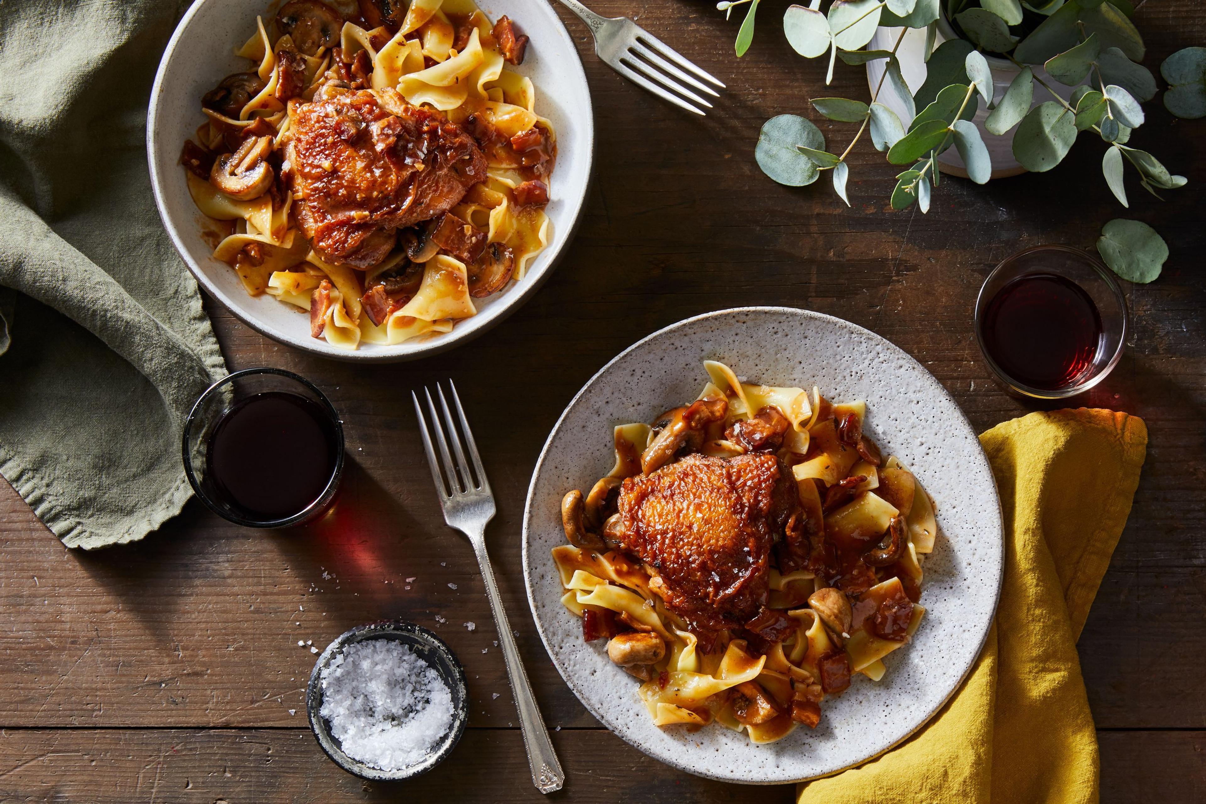 two bowl of roast chicken and noodles on table