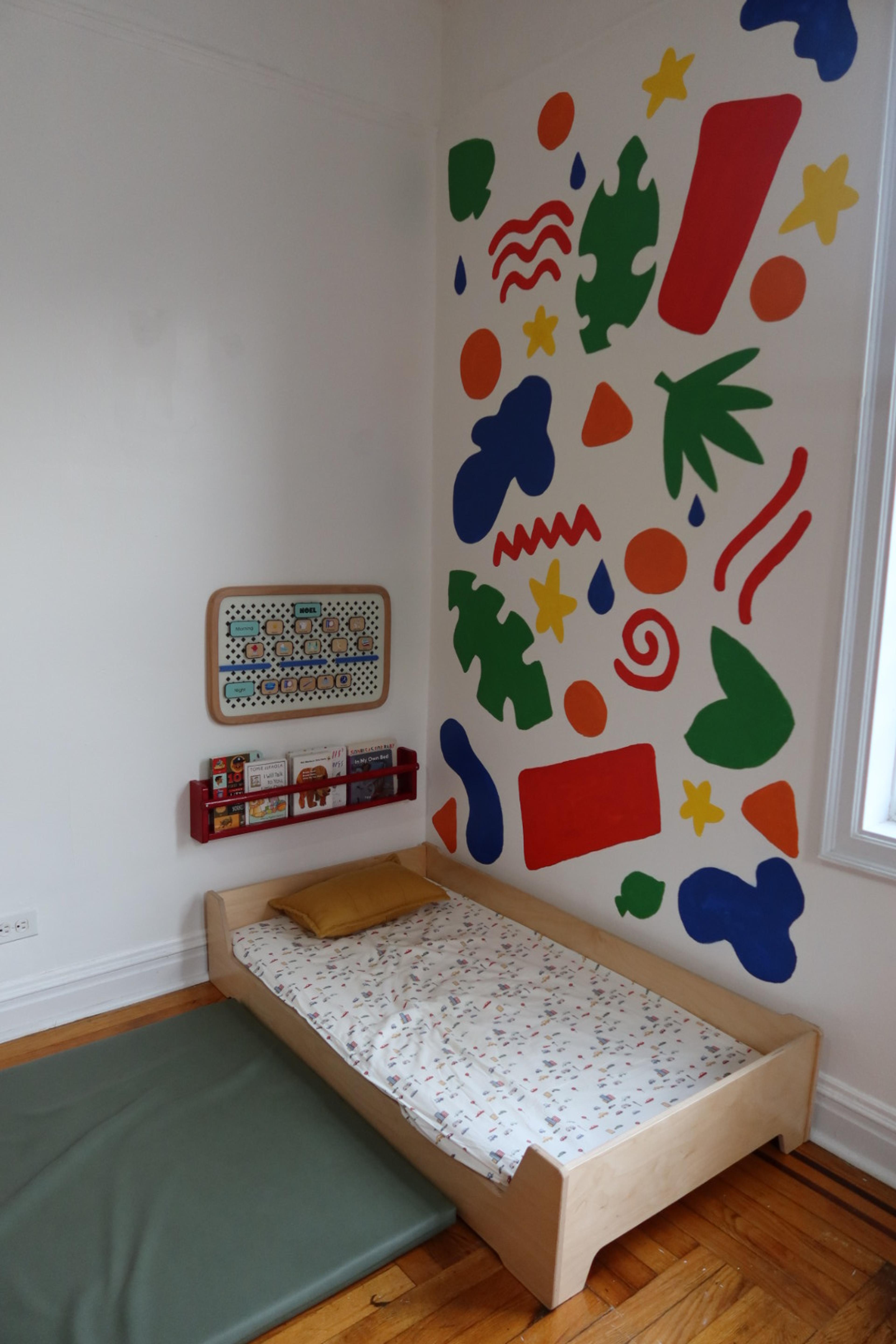 crib in kids room under painted wall in main bedroom