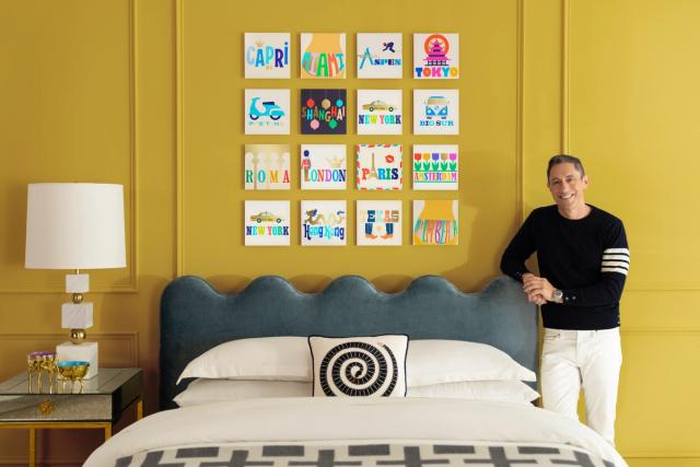 Jonathon Adler posing next to couch, gold wall, and TilePix collab