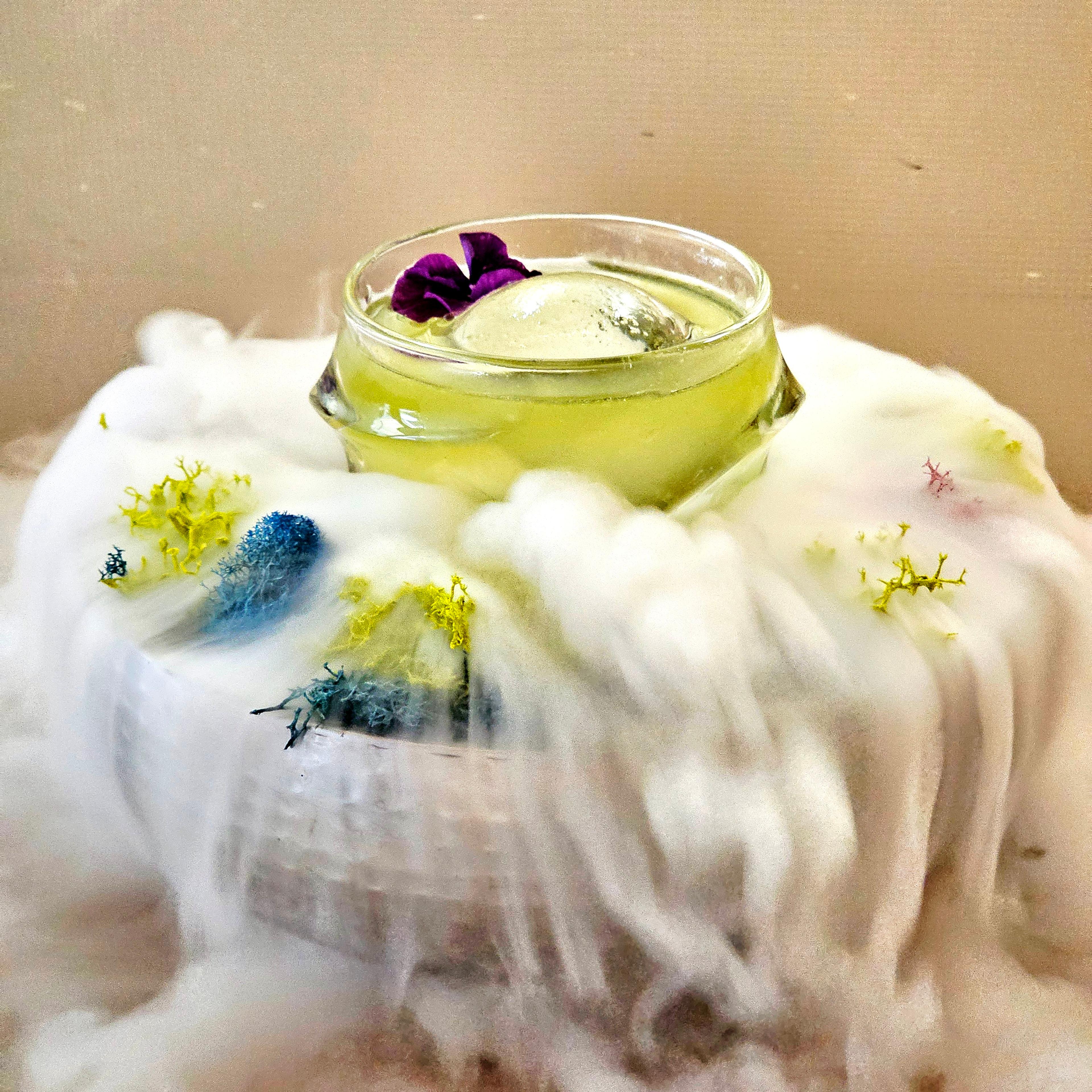 green spooky cocktail in punch bowl of dry ice