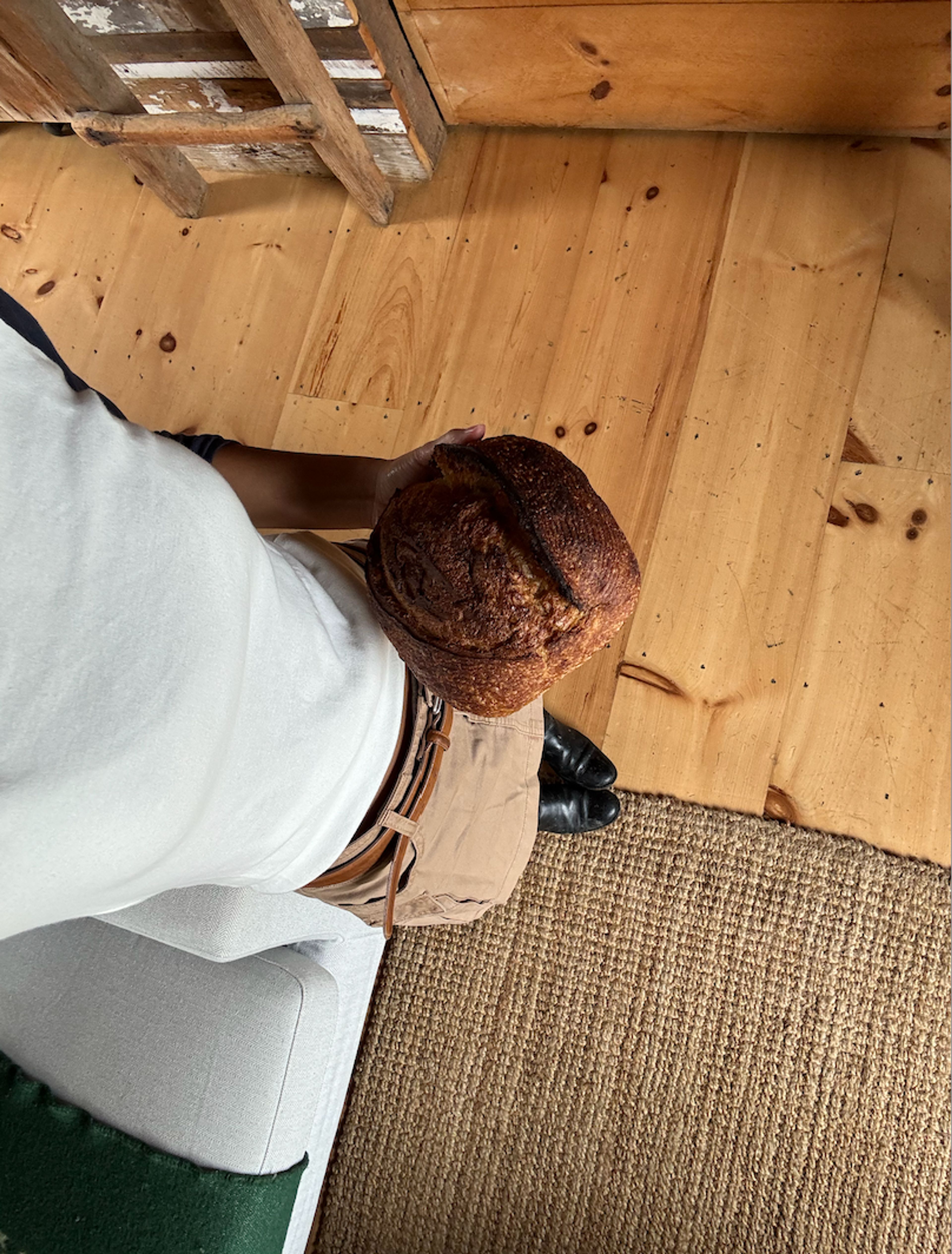 estro studio owner holding loaf of bread