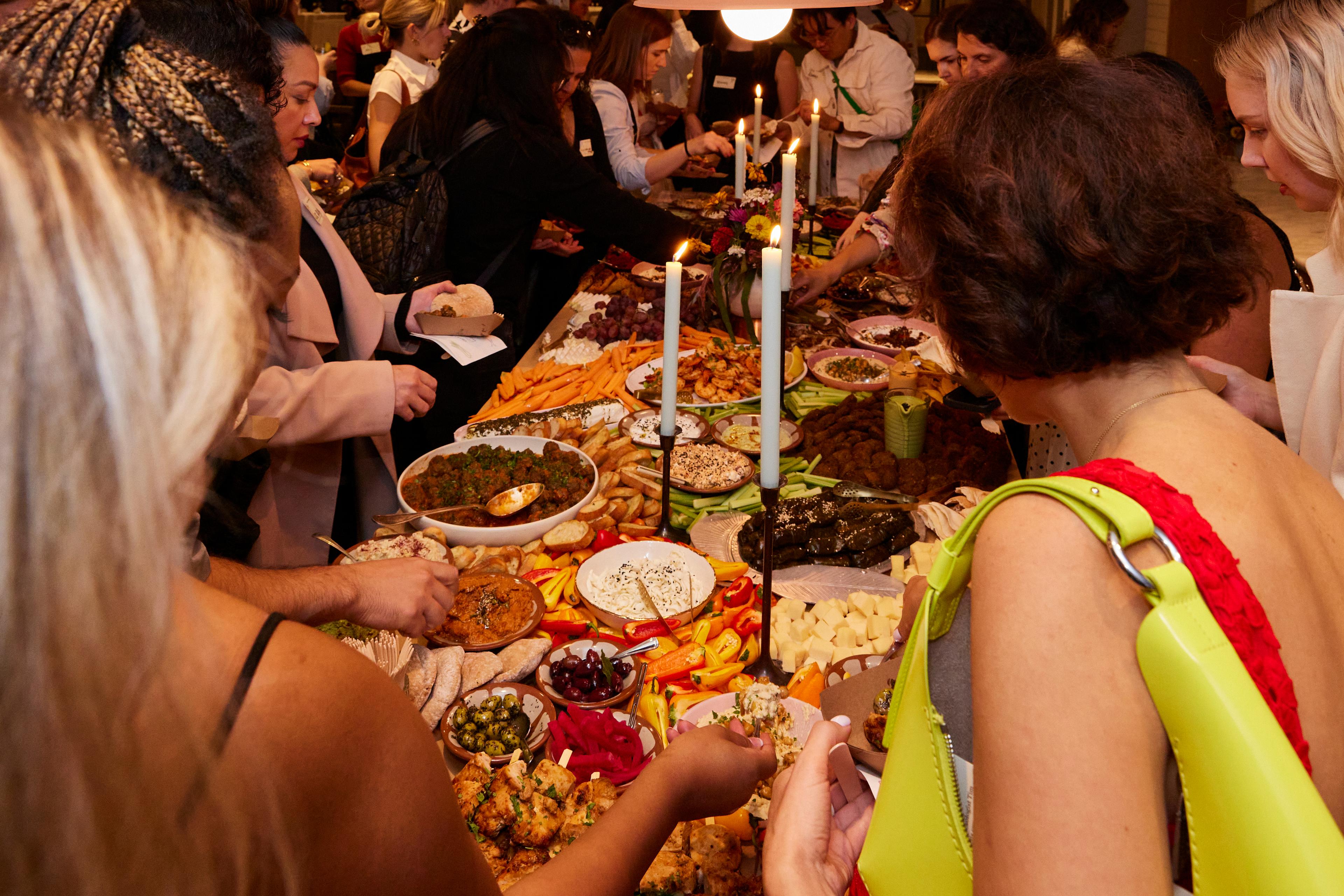 people adding to plates at charcuterie table