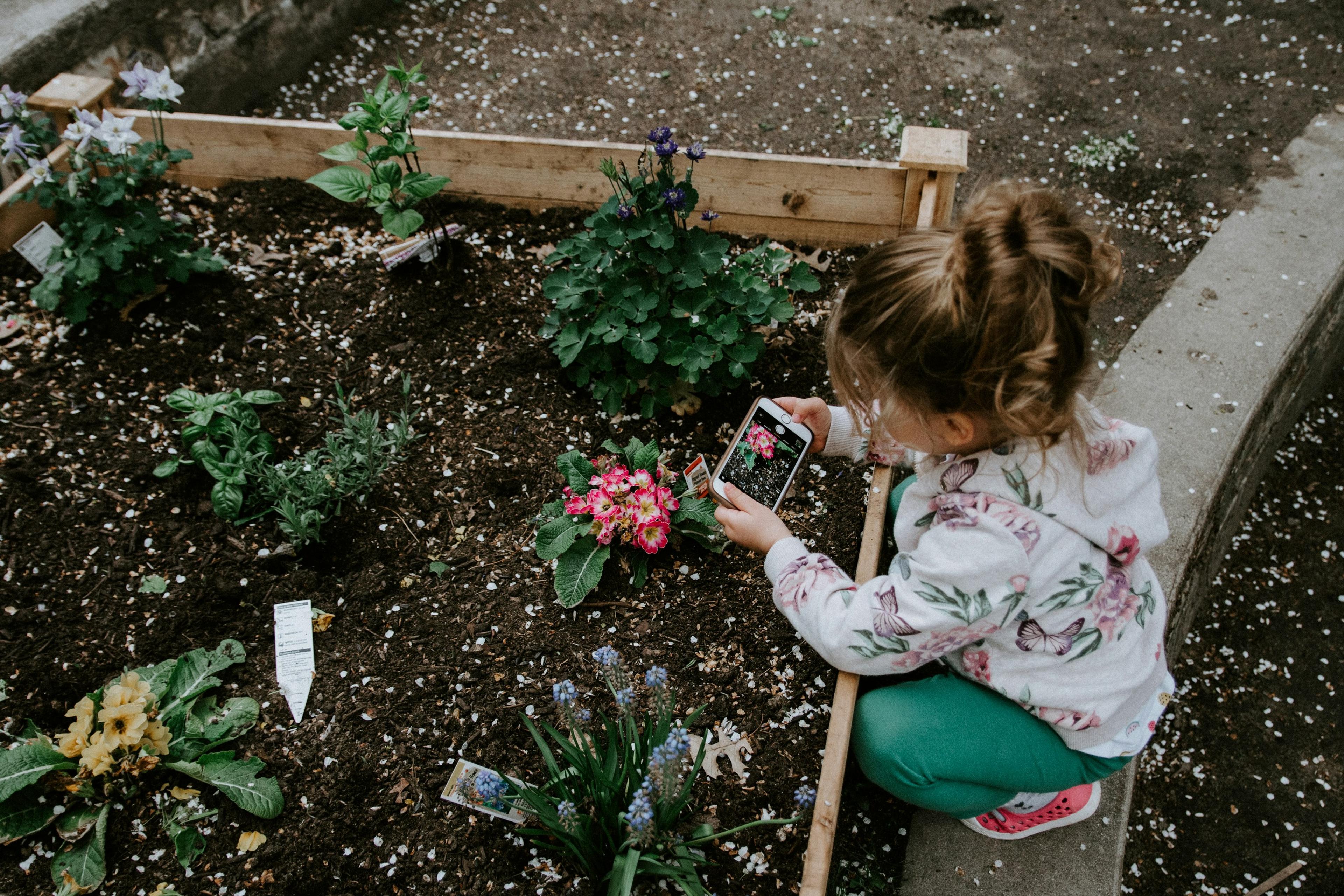 young girl gardening with mom