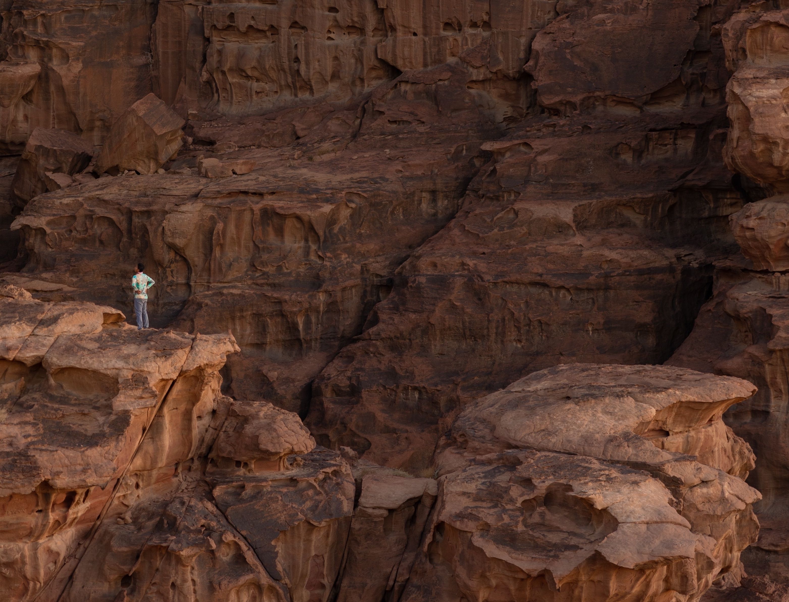 Person standing within red rock formations