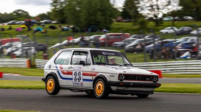Period-correct motorsport graphics applied to a race vehicle.