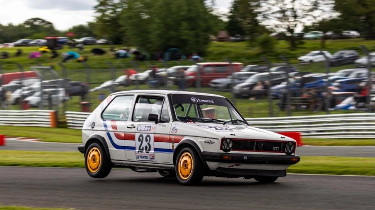 Period-correct motorsport graphics applied to a race vehicle.
