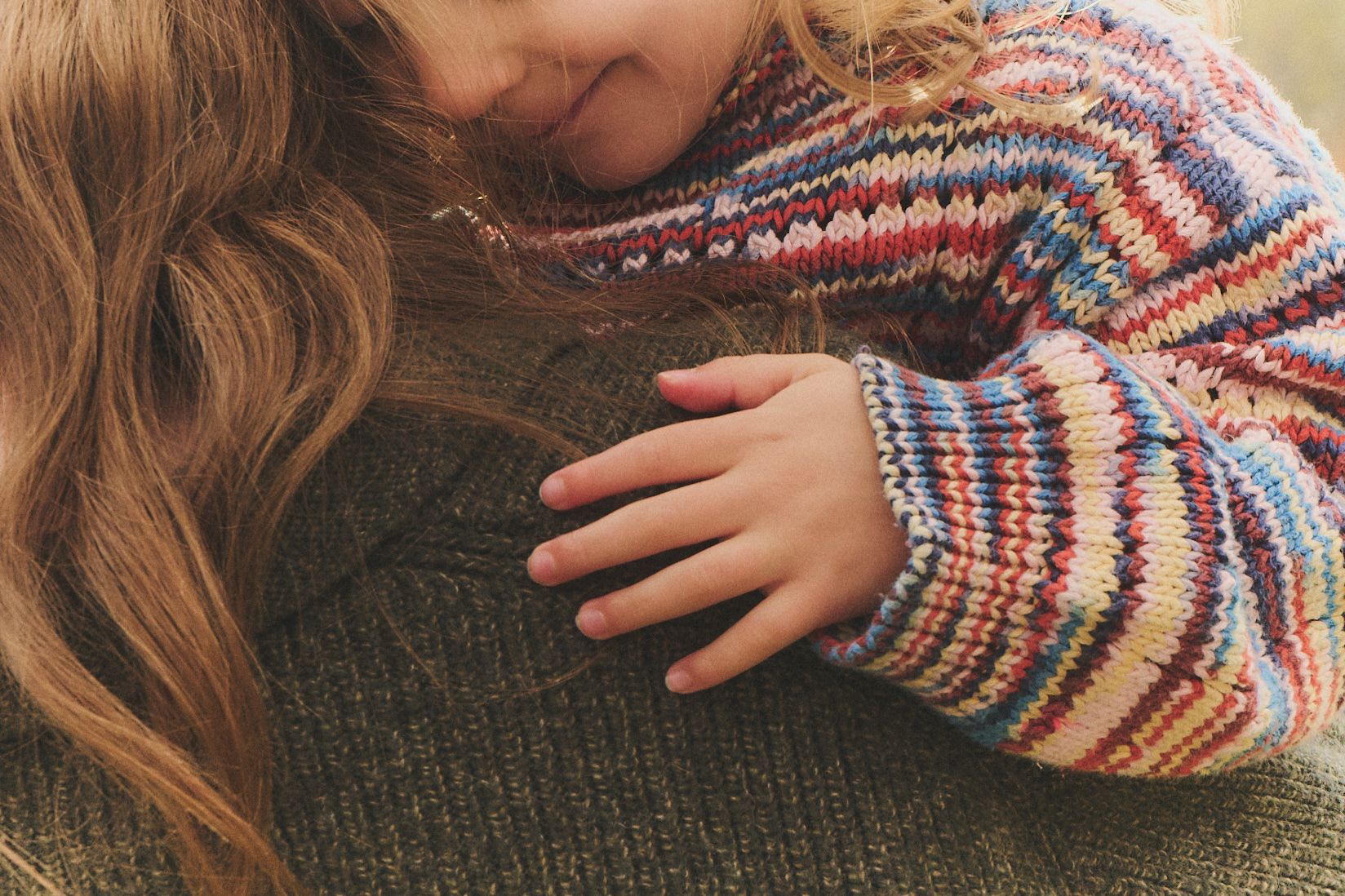 child embracing woman