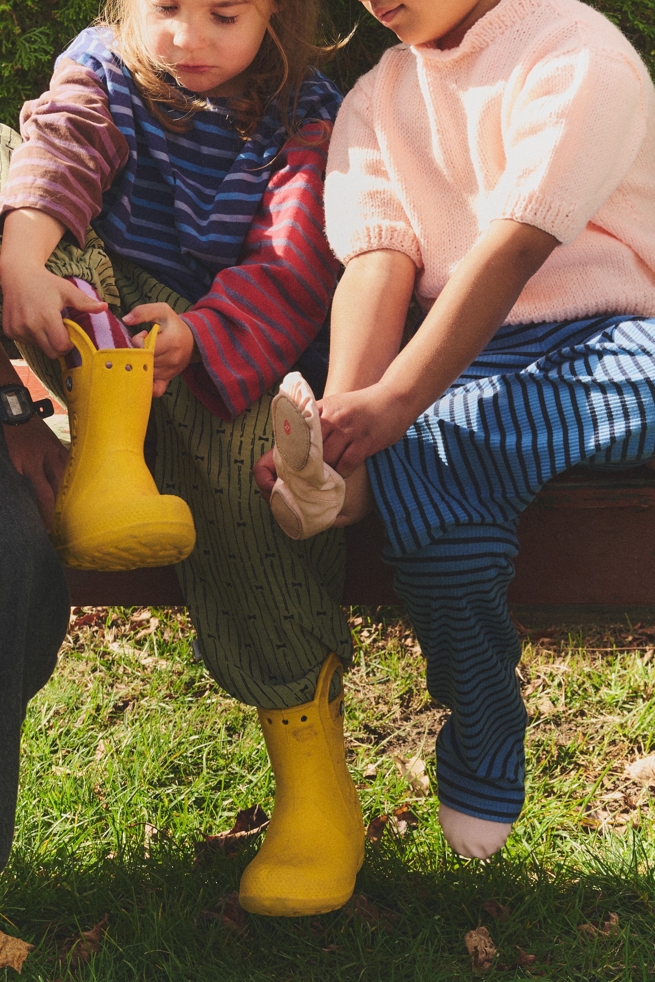 kids putting on their rain shoes