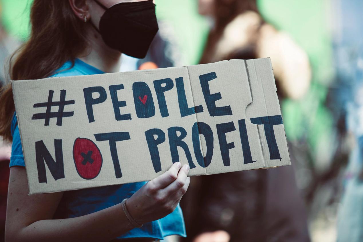 Young protester holding a sign at a rally