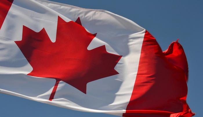 A Canadian flag waving in the wind