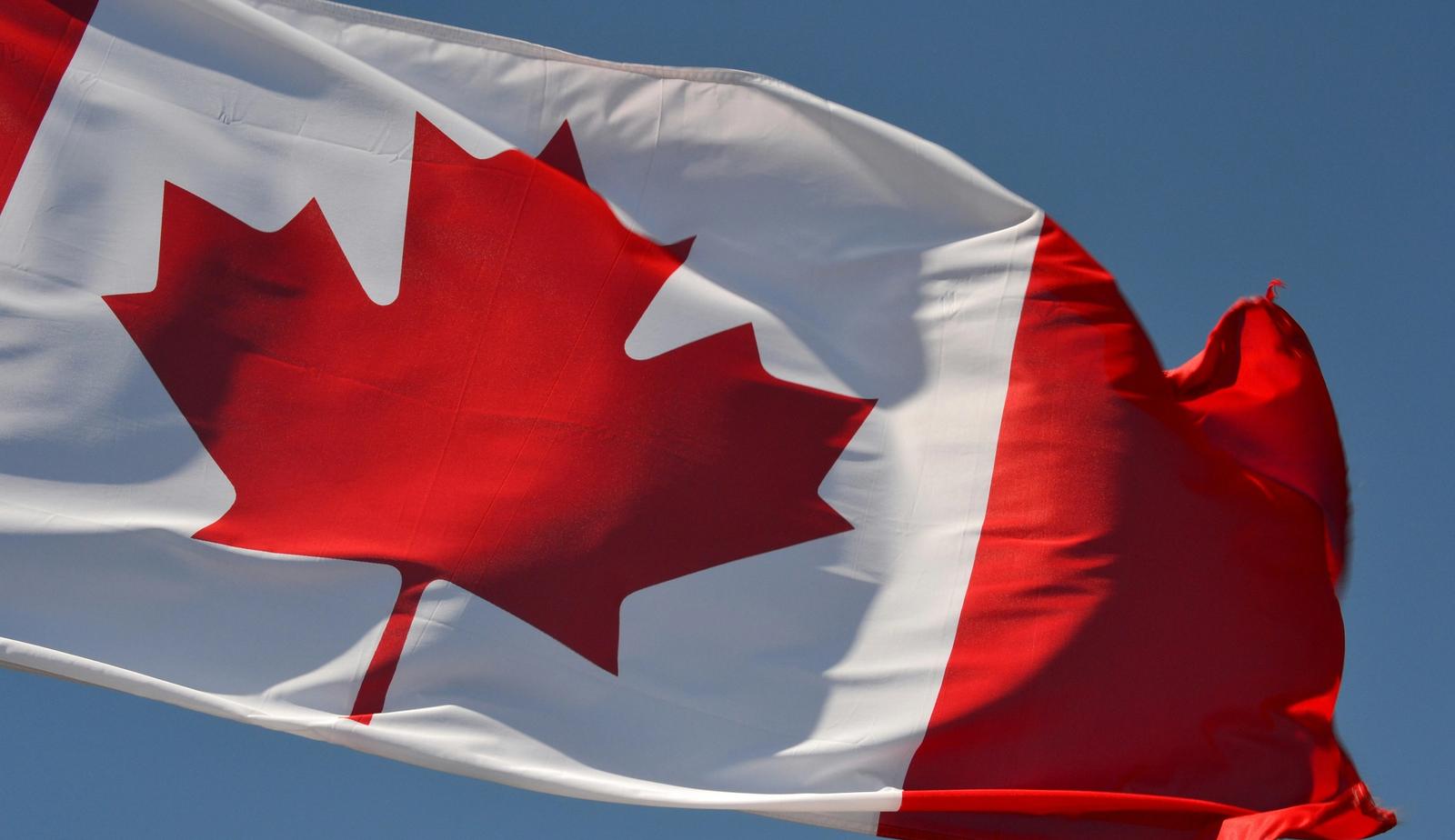 A Canadian flag waving in the wind