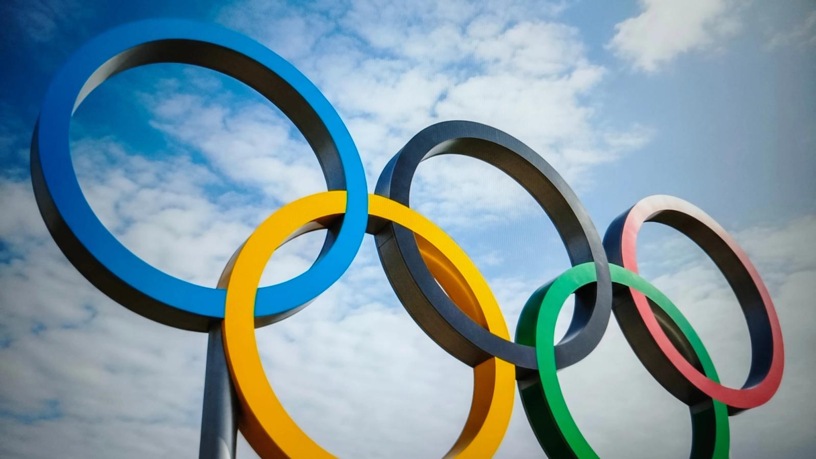 Olympic rings with a cloudy sky in the background