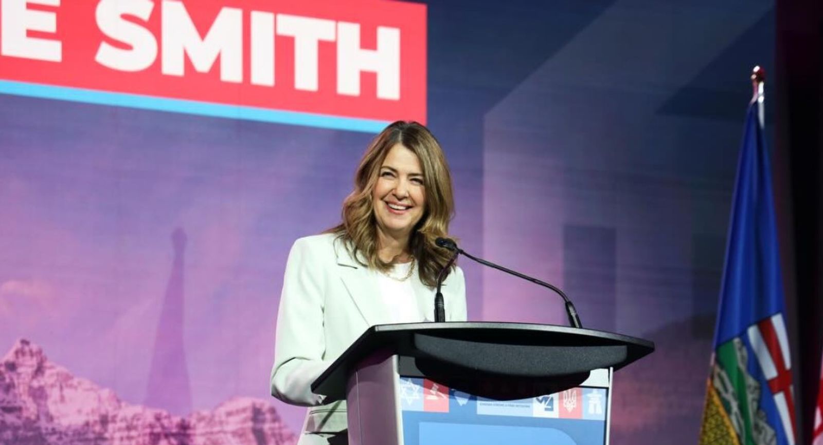 Alberta Premier Danielle Smith speaking at a podium