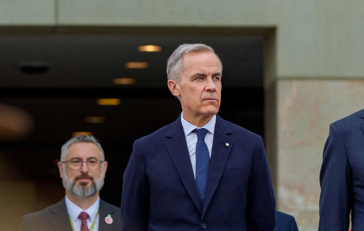 Mark Carney is standing in front of a crowd in Canberra, Australia