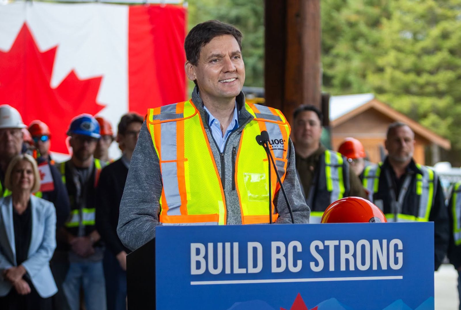 David Eby standing at a podium during one of his campaign stops