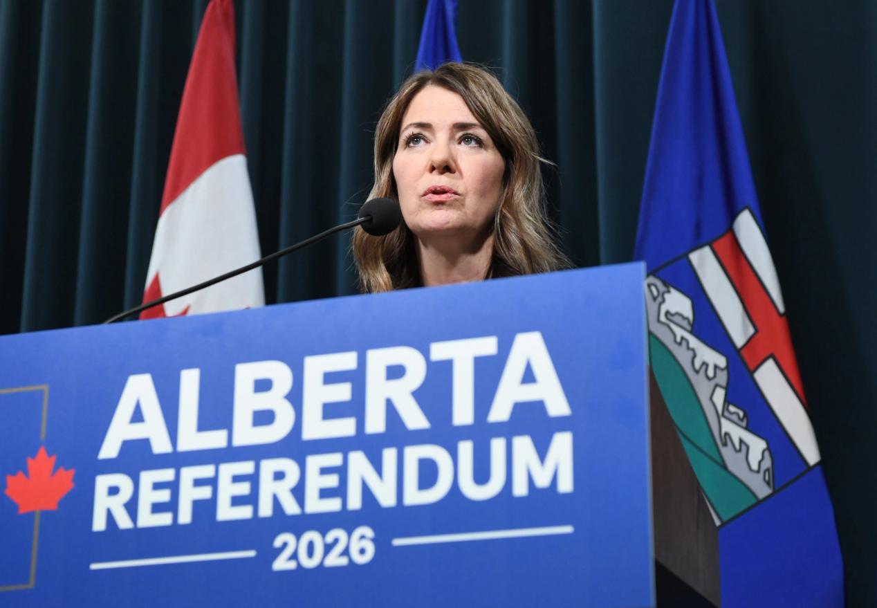Alberta Premier Danielle Smith standing at a podium announcing the provincial referendum