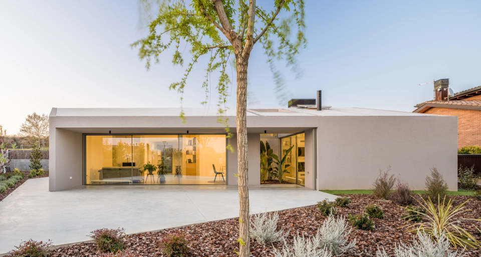This single-family home embraces a serene and horizontal architecture, with clean volumes and large glass enclosures that enhance natural light and visual continuity with the outdoors. Open spaces, interior courtyards, and minimalist materiality create a contemporary home designed for comfort, privacy, and a constant relationship with the landscape.